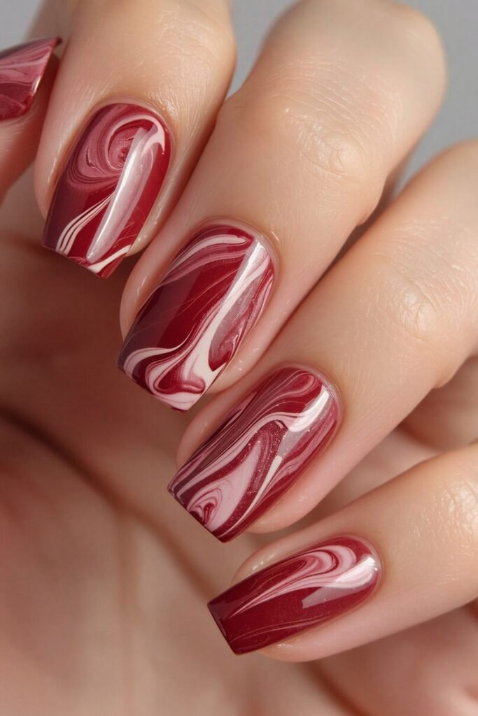 Festive fall nails with plum base and metallic confetti accents